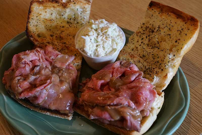 Roast beef sandwich with side of garlic bread