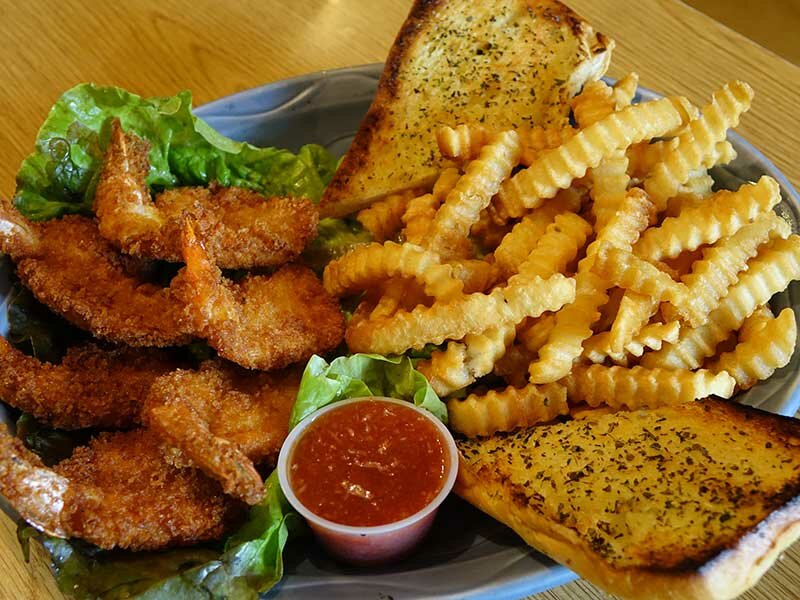 Fried shrimp with side of french fries and garlic bread